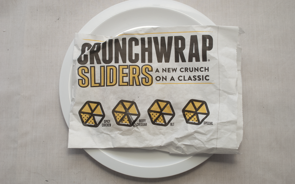 A Crunchwrap Slider wrapper, marked Beefy Cheddar.