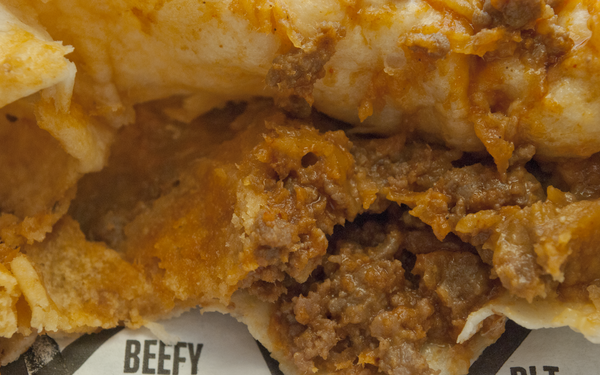 An interior shot of the Crunchwrap Slider's cheddary beef.