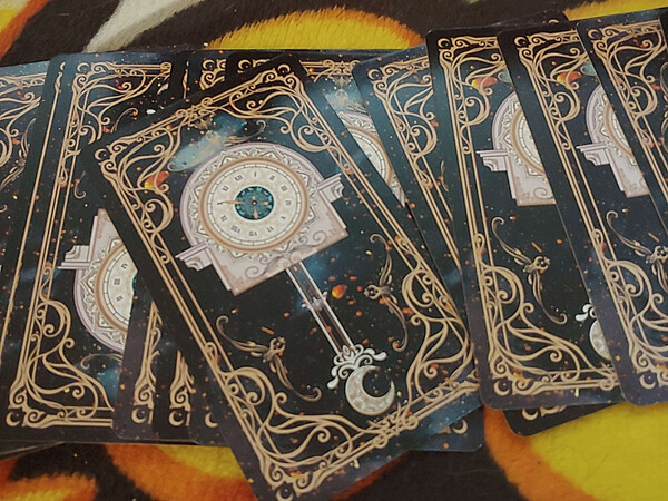 The cards. They have an overcomplicated but nondescript design of a clock and a moon.