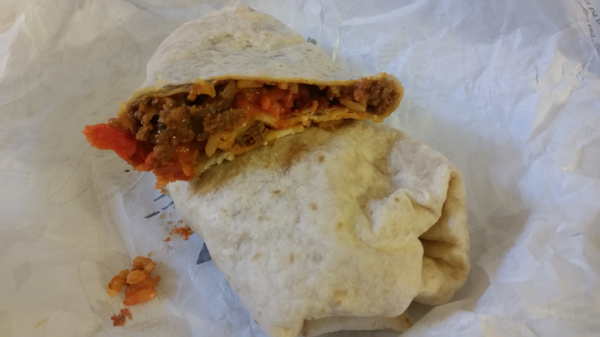 A burrito with a bite taken out of it.