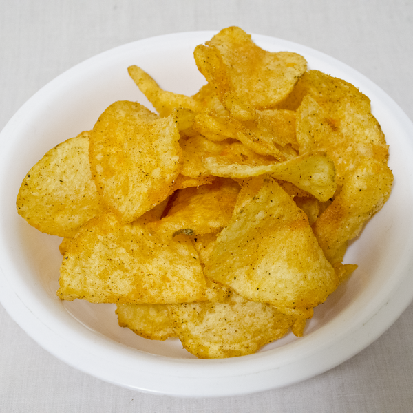 The chips poured out into a bowl. They are orange.