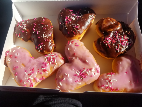 A box of very misshapen heart-shaped donuts.