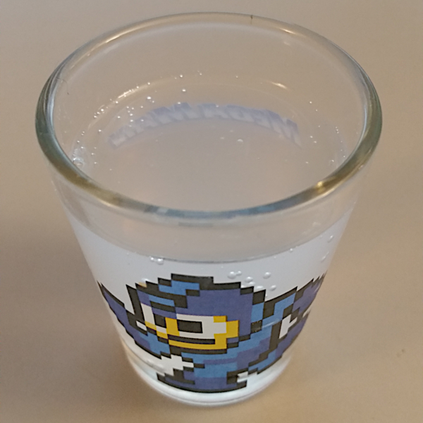 VooDew in a shot glass. It's clear and fizzy.