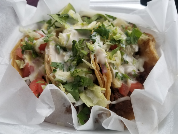 A styrofoam container of tacos