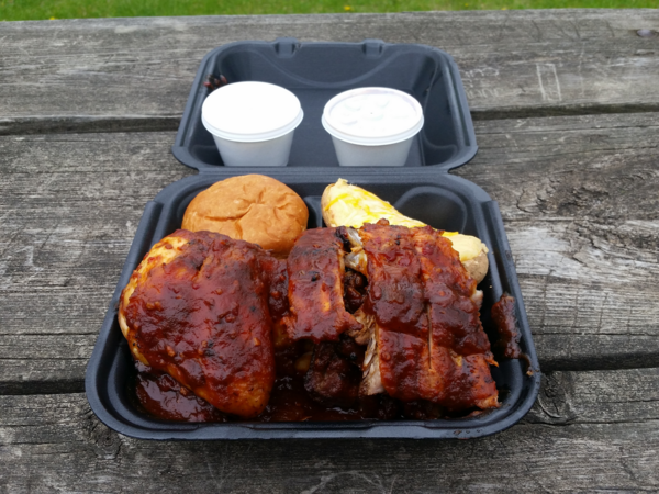 A styrofoam container of food, described below